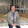 Pastor Rick Mayo sits at the edge of the stage being constructed in the new sanctuary that will soon be the new home of Cornerstone Pentecostal Church. 
