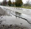 Cracks and crevices in Valleyway Avenue pool with water during a recent spring rainstorm. Valleway would receive an overhaul this year if the first phase in a multi-year street maintenance plan is approved.