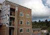 The 50-unit Broadwing apartment complex, left, going up near First Liberty Apartments and Talon Hills provides income-restricted housing for families.