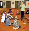 Justin Collyer, health and fitness teacher, explains an activity to students attending Greenacres Elementary School�s Fit for Bloomsday Club.
